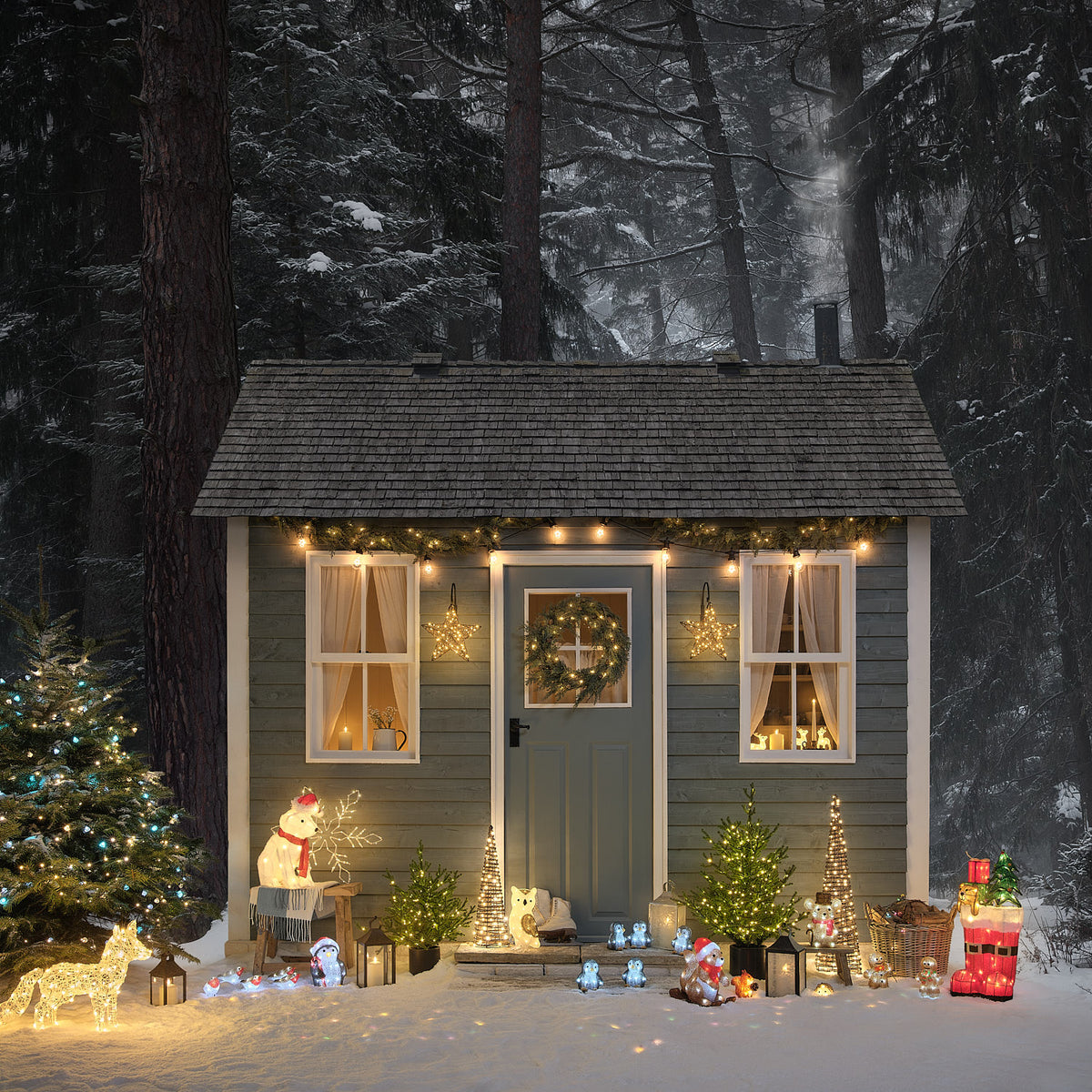 Winterliche Gartendeko mit beleuchtetem LED Polarfuchs und weiteren Figuren vor einem Holzhaus