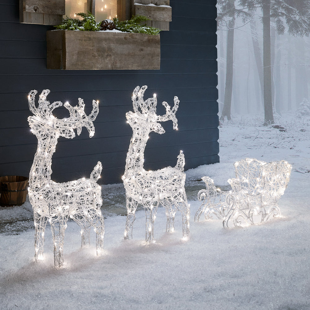 Bicolor LED-Rentiere mit Schlitten Swinsty