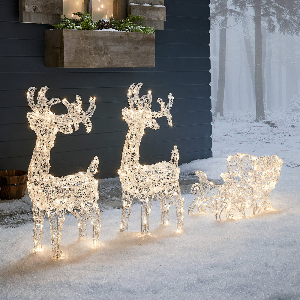 Bicolor LED-Rentiere mit Schlitten Swinsty